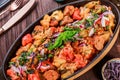 Baked chicken with grilled vegetables, greens, lavash in pan on wooden table. Hot Meat Dishes. Royalty Free Stock Photo