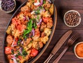 Baked chicken with grilled vegetables, greens, lavash in pan on wooden table. Hot Meat Dishes. Royalty Free Stock Photo