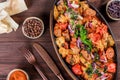 Baked chicken with grilled vegetables, greens, lavash in pan on wooden table. Royalty Free Stock Photo