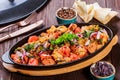 Baked chicken with grilled vegetables, greens, lavash in pan on wooden table. Royalty Free Stock Photo