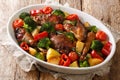 Baked chicken recipe with potatoes, broccoli, tomatoes and sweet pepper close-up in a baking dish. horizontal