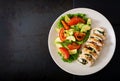 Baked chicken rolls with greens and olives, and baked vegetables - zucchini and tomatoes