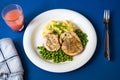 Baked chicken roulade stewed pea and mashed potato on plate on table Royalty Free Stock Photo