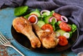 Baked chicken with a side dish of vegetable salad on the old, bl