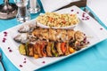 Baked chicken skewers with lemon, vegetables, pepper, zucchini, eggplants and grilled tomatoes with spices, and steamed rice Royalty Free Stock Photo