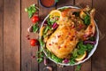 Baked chicken stuffed with rice for Christmas dinner on a festive table. Royalty Free Stock Photo