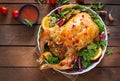 Baked chicken stuffed with rice for Christmas dinner on a festive table. Royalty Free Stock Photo