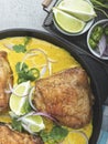 Baked chicken thigh, legs with curry sauce, lime, spices Royalty Free Stock Photo