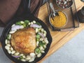 Baked chicken thigh with white beans in a portion pan Royalty Free Stock Photo