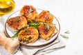 Baked chicken thighs with herbs on white plate. Royalty Free Stock Photo