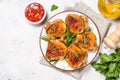 Baked chicken thighs with herbs on white plate. Royalty Free Stock Photo