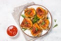 Baked chicken thighs with herbs on white plate. Royalty Free Stock Photo