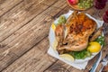 Baked chicken, wine glasses and fruit for dinner on the festive table copy space