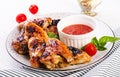 Baked chicken wings in the Asian style and tomatoes sauce Royalty Free Stock Photo