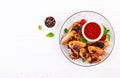 Baked chicken wings in the Asian style and tomatoes sauce on plate. Royalty Free Stock Photo