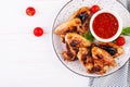 Baked chicken wings in the Asian style and tomatoes sauce on plate. Royalty Free Stock Photo