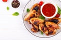 Baked chicken wings in the Asian style and tomatoes sauce on plate. Royalty Free Stock Photo