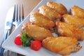 Baked chicken wings white dish cutlery Royalty Free Stock Photo