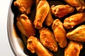 Baked chicken wings in a frying pan. Close-up. Generative AI Royalty Free Stock Photo