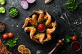 Baked chicken wings in a pan with ketchup and onions. Barbecue. Top view. Royalty Free Stock Photo