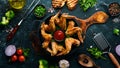 Baked chicken wings in a pan with ketchup and onions. Barbecue. Top view. Royalty Free Stock Photo