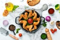 Baked chicken wings in a pan with ketchup and onions. Barbecue. Top view. Royalty Free Stock Photo