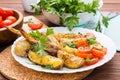 Baked chicken wings and potatoes, fresh tomatoes and greens Royalty Free Stock Photo