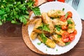 Baked chicken wings and potatoes, fresh tomatoes and greens Royalty Free Stock Photo