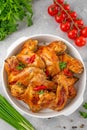 Baked chicken wings served with sweet chili sauce and fresh herbs. Selective focus Royalty Free Stock Photo