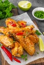 Baked chicken wings served with sweet chili sauce and fresh herbs. Selective focus Royalty Free Stock Photo