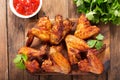 Baked chicken wings on wooden table Royalty Free Stock Photo