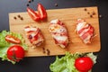 Baked chicken wrapped in bacon. Delicious appetizer with crispy smoked bacon. Chicken breast wrapped in bacon on wooden board. Royalty Free Stock Photo