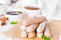 Baked churros with cinnamon, powdered sugar, chocolate and caramel sauce.