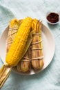 Baked corn with chili sauce Royalty Free Stock Photo