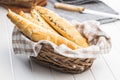 Baked croissant in basket. Crispy bun roll on white table Royalty Free Stock Photo