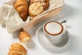 Baked croissants and pastry with a cup of coffee on marble table,