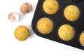 Baked cupcake cakes in a muffin tin and eggshells isolated with shadows on a white background, high angle view from above, copy