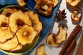 Baked dehydrated apple slices and cinnamon. Homemade dry fruit chips, autumn fall snack, healthy vegan food