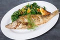 Baked dorado with warm spinach salad