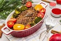 Baked duck breast on the bone with vegetables and sauce. Christmas dinner concept, New Year table setting. Stone concrete