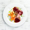 Baked duck breast with celery root and vegetables on a white plate. Royalty Free Stock Photo