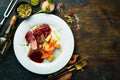 Baked duck breast with celery root and vegetables on a white plate. Royalty Free Stock Photo