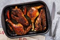 Baked duck with grilled oranges in a baking tray on the table