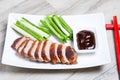 Baked duck with hoisin sauce, cucumbers and shallots. Royalty Free Stock Photo