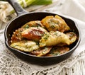 Baked dumplings on a cast-iron frying pan