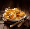 Baked dumplings pierogi with mushroom stuffing in a ceramic bowl on a wooden table