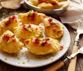 Baked dumplings stuffed with curd cheese and potatoes on a white plate, Traditional Polish dish Royalty Free Stock Photo