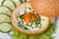 Baked egg in a bun and vegetables top view Royalty Free Stock Photo