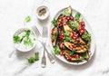 Baked eggplant with feta, greek yogurt, cilantro sauce and pomegranate seeds on light background, top view. Delicious snack, tapas Royalty Free Stock Photo