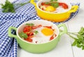 Baked eggs with cheese, tomatoes and peppers.